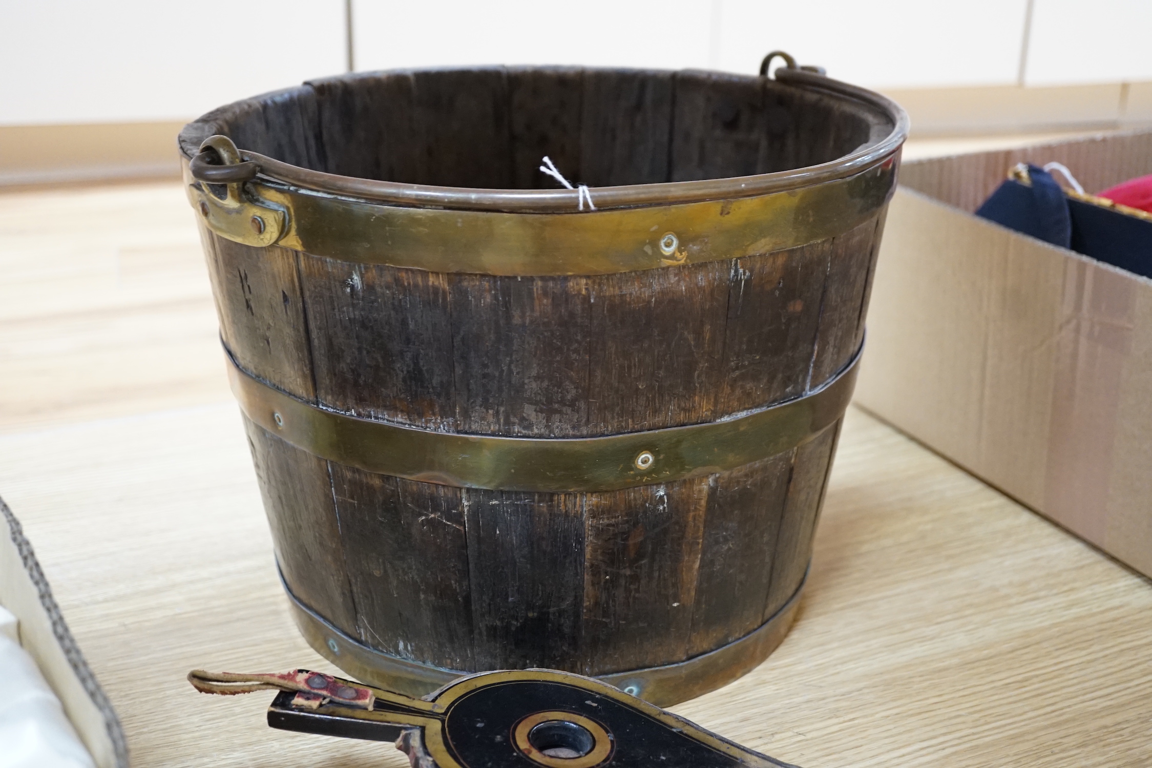 A coopered brass bound oak bucket and a small pair of lacquered bellows